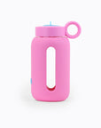 Glass water bottle with a protective silicone sleeve and screw on cap in pink.