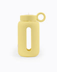 Glass water bottle with a protective silicone sleeve and screw on cap in yellow.