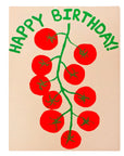 Happy Birthday card with red tomatoes and green leaves on a wooden surface