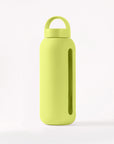 Glass water bottle with a protective silicone sleeve and screw on cap lime green.