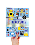 Book titled 'Design Your Own Stickerbots' held by a hand on a white background