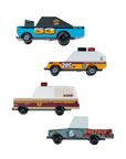 Four toy trucks with different designs and numbers on a light gray background