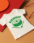 White tee screen printed in green ink text BIBIMBAP above pot of smiling bibimbap, chopsticks, and a spoon.