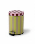 Striped trash can with pink top and green body on a white background