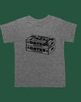 Gray tee with black screen sprint of two boxes of dates with the words Dates, Yum, Made in Palestine on the boxes.
