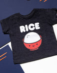 Black tee screen printed with white ink text RICE above a red smiling bowl full of white rice.