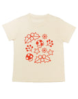White tee screen printed with smiling mistletoe, snowflakes, mushrooms, leaves, and stars in red.