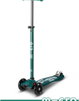 Three wheel scooter with extendable handle bar in Green and White.
