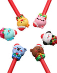 Colorful christmas characters on top of red pens.