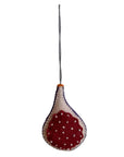 Fig hanging ornament with red and white pattern on a plain background