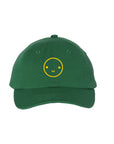 Green baseball hat with yellow embroidered smiley face.