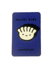 A blue rectangular card with the text 'mochi kids enamel pin' and a hard enamel pin featuring a stylized design of a gyoza (dumpling) with a smiling face.