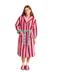 Woman wearing a pink and red striped robe with colorful trim.