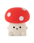 Mushroom shaped night light with cute face and red cap and white spots.