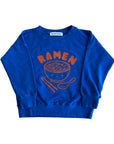 Blue sweatshirt screen printed with orange ink text RAMEN above a bowl of ramen with a smiley face, chopsticks, and soup spoon.