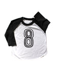 Baseball tee white with black sleeves screen printed with black number 8.