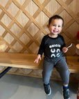A child modeling a gray baseball tee with black sleeves printed with white text ONIGIRI above four smiling onigiri.