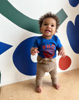 A baby modeling a blue tee screen printed with red ink text Pho above a smiling bowl of Pho.