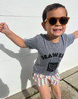 A child modeling a grey tee screen printed with black ink with text reading SEAWEED above a smiling package of seaweed.