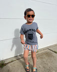 A child modeling a grey tee screen printed with black ink with text reading SEAWEED above a smiling package of seaweed.