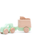teal blue car towing wooden horse toy