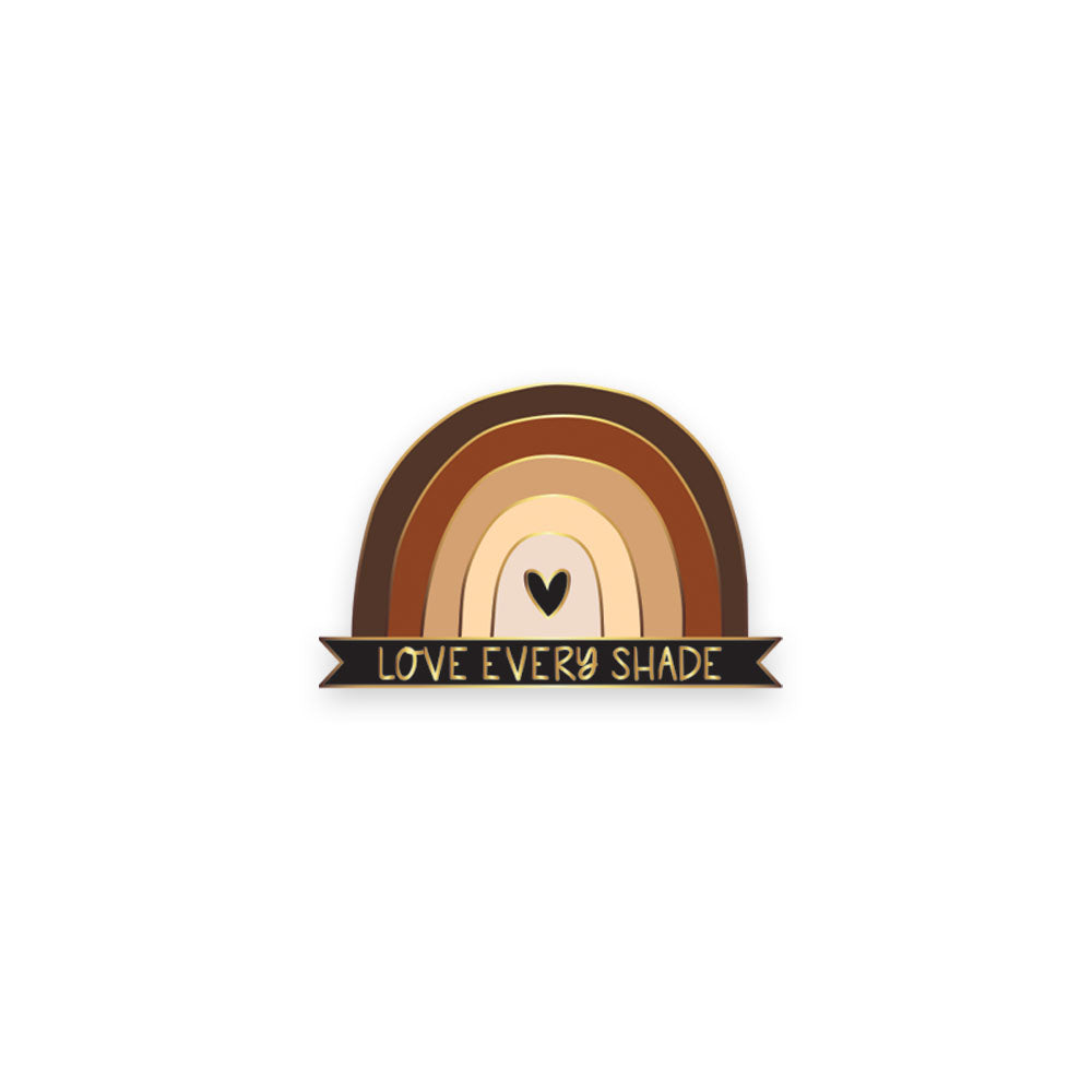 Enamel pin of a rainbow with different skin tone shades and a black banner along the bottom that reads "Love Every Shade"