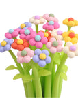 Colorful flower-shaped pens on a white background