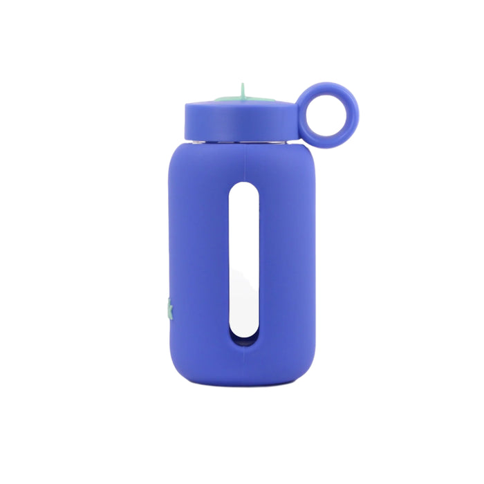 Glass water bottle with a protective silicone sleeve and screw on cap in navy.