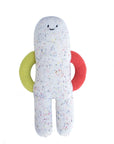 White plush toy with colorful speckles and red and green rings on a white background