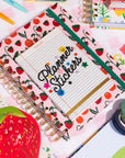 Notebook with strawberry pattern and 'Planner Stickers' text on a colorful background