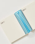 Blue and white spiral notebook on a white surface