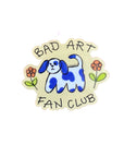 A sticker with a blue and white spotted dog illustration and text 'Bad Art Fan Club' with some doodly flowers.