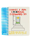 Notebook with blue spiral binding and 'Things I'm Looking Forward To' title on a white background