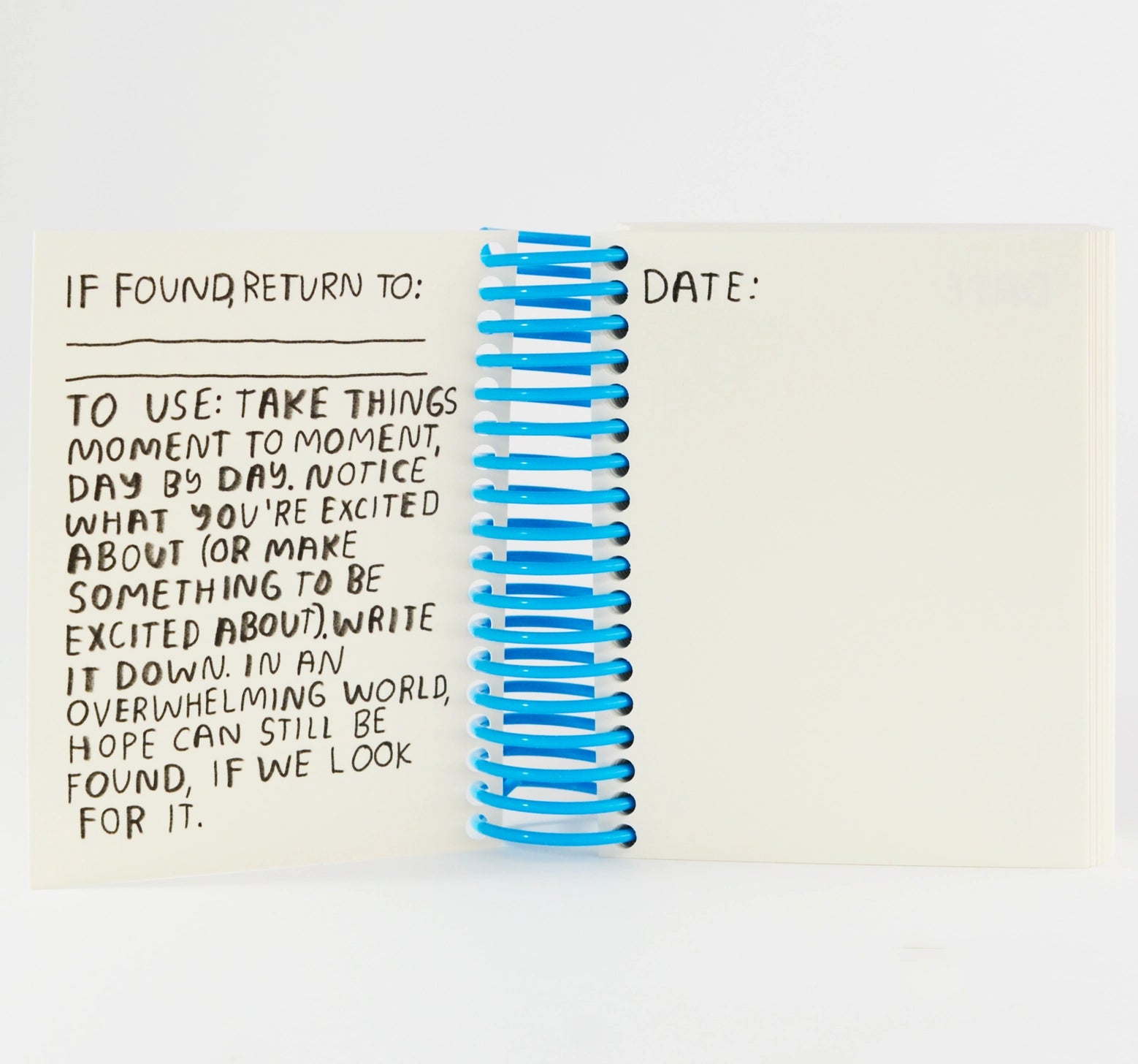 Notebook with spiral binding and text on a white background