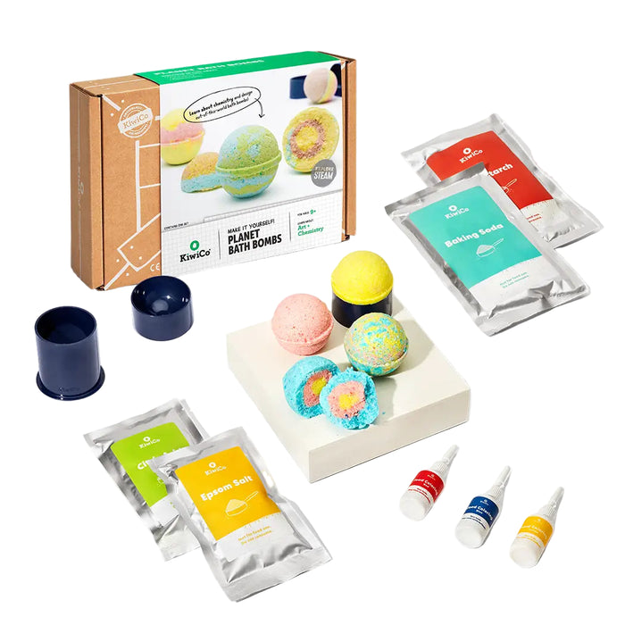 Bath bomb kit with colorful bath bombs, packaging, and ingredients on a white background