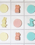 Colorful soaps, examples of what kids can make with this product. Teal, yellow, and pink soaps were made as examples.