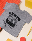 Grey tee screen printed with black ink text BENTO above a black smiling bento box lunch with chopsticks.