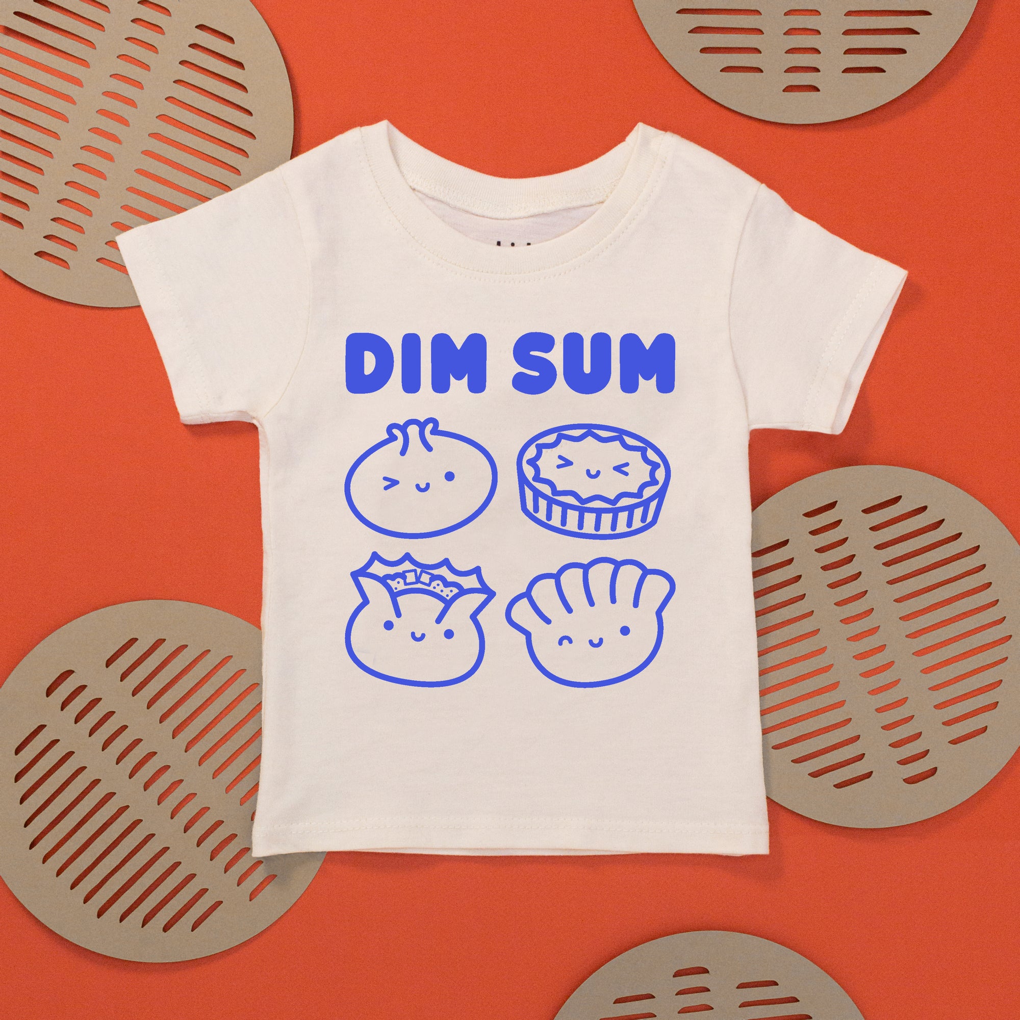White tee with screen printed with blue ink text DIM SUM and four smiling Dim Sum dumplings.