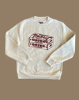 Beige sweater with maroon screen sprint of two boxes of dates with the words Dates, Yum, Made in Palestine on the boxes. 