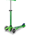 A Green and Blue three wheeled push scooter with the front two wheels lit up with LED lights.