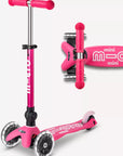 A pink and white three wheeled push scooter with the front two wheels lit up with LED lights.