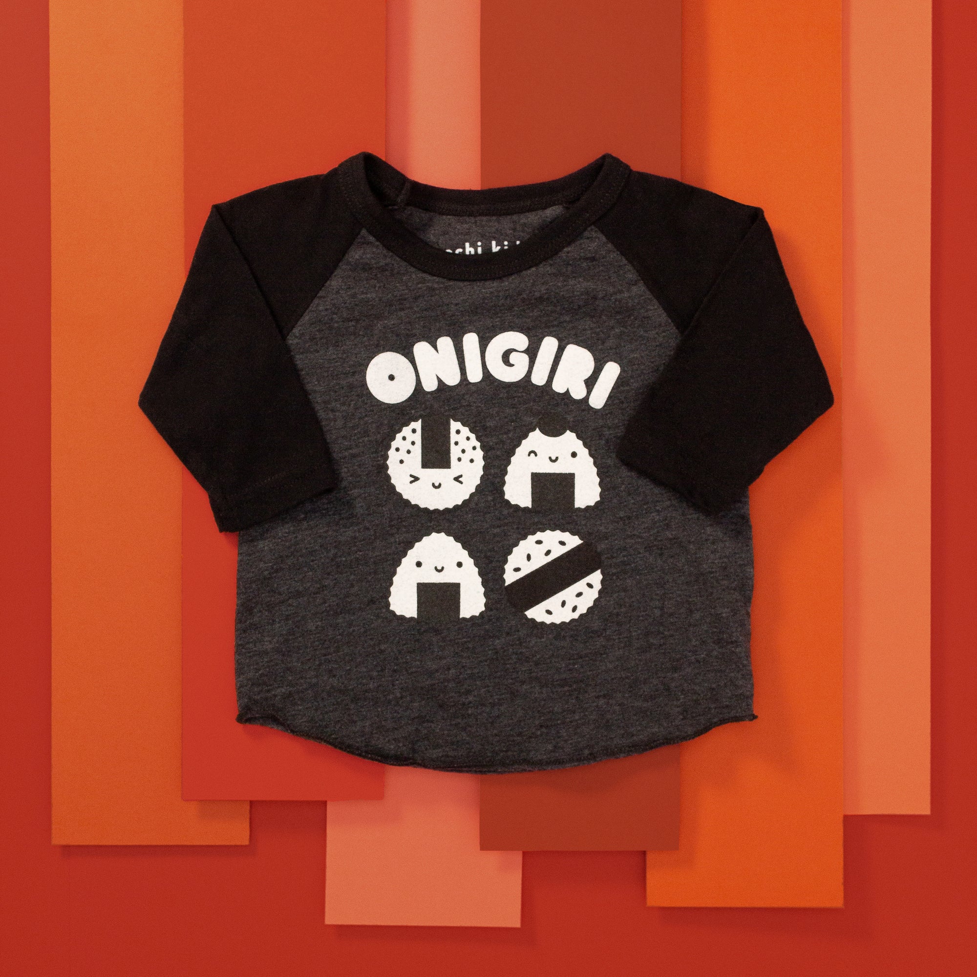 Grey baseball tee with black sleeves printed with white text ONIGIRI above four smiling onigiri.
