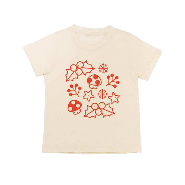 White tee screen printed with smiling mistletoe, snowflakes, mushrooms, leaves, and stars in red.