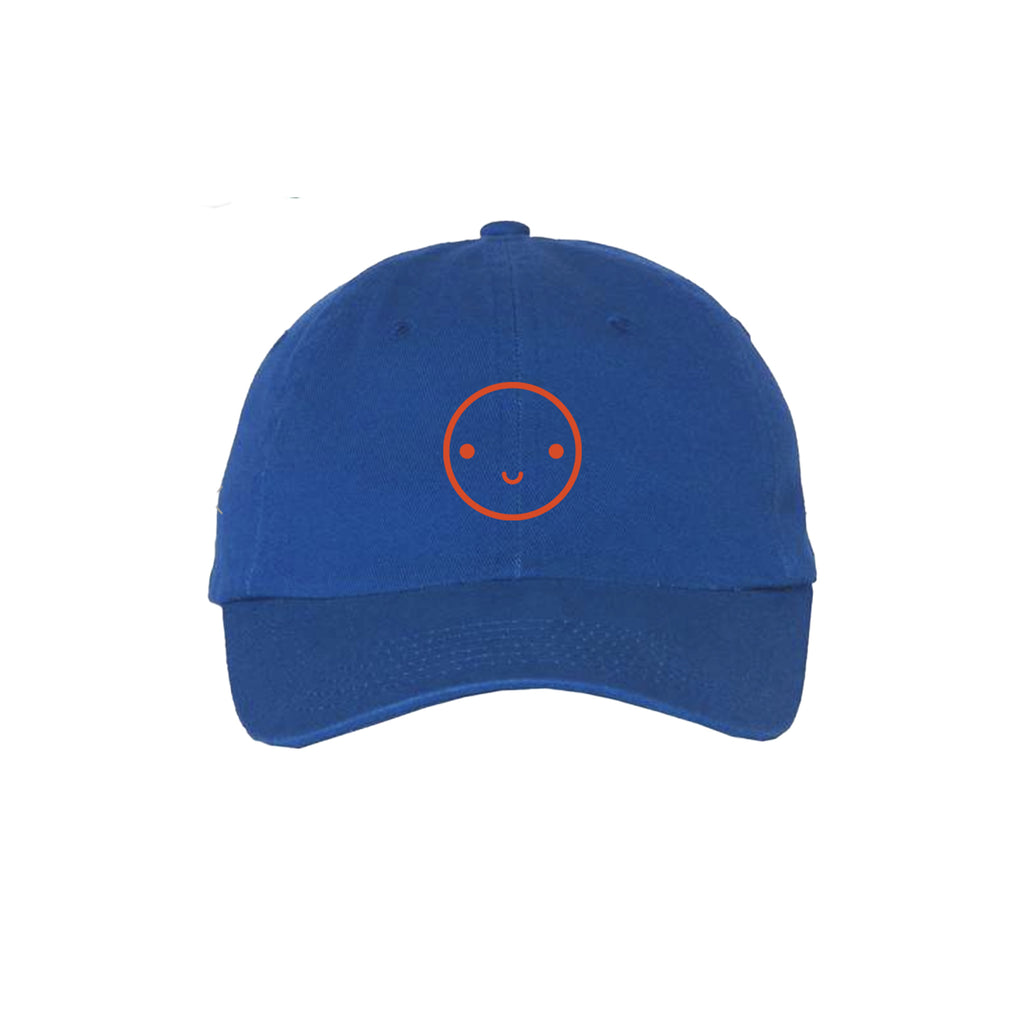 Blue baseball hat with red embroidered smiley face.