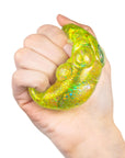 A hand squishing a green cat paw shaped squishy toy. 