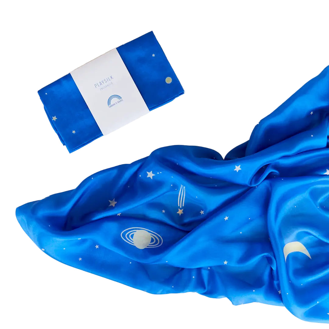 Blue fabric with celestial patterns and a folded packaging on a white background