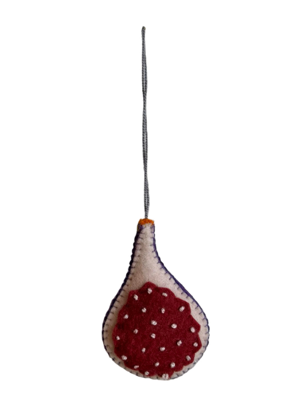 Fig hanging ornament with red and white pattern on a plain background