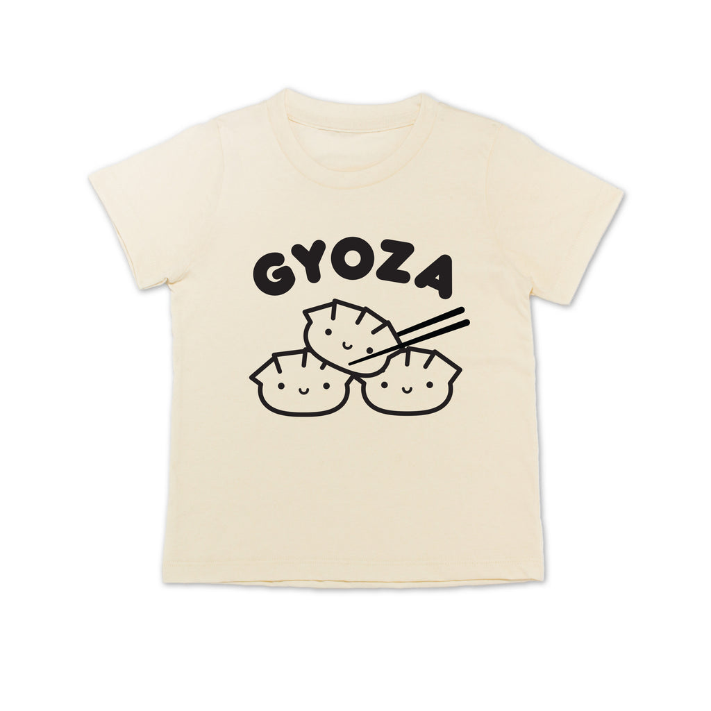 White tee with screen printed black ink text GYOZA above three smiling dumplings.