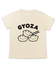 White tee with screen printed black ink text GYOZA above three smiling dumplings.