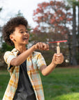 A child pulling the wind up string on a hand helicopter.